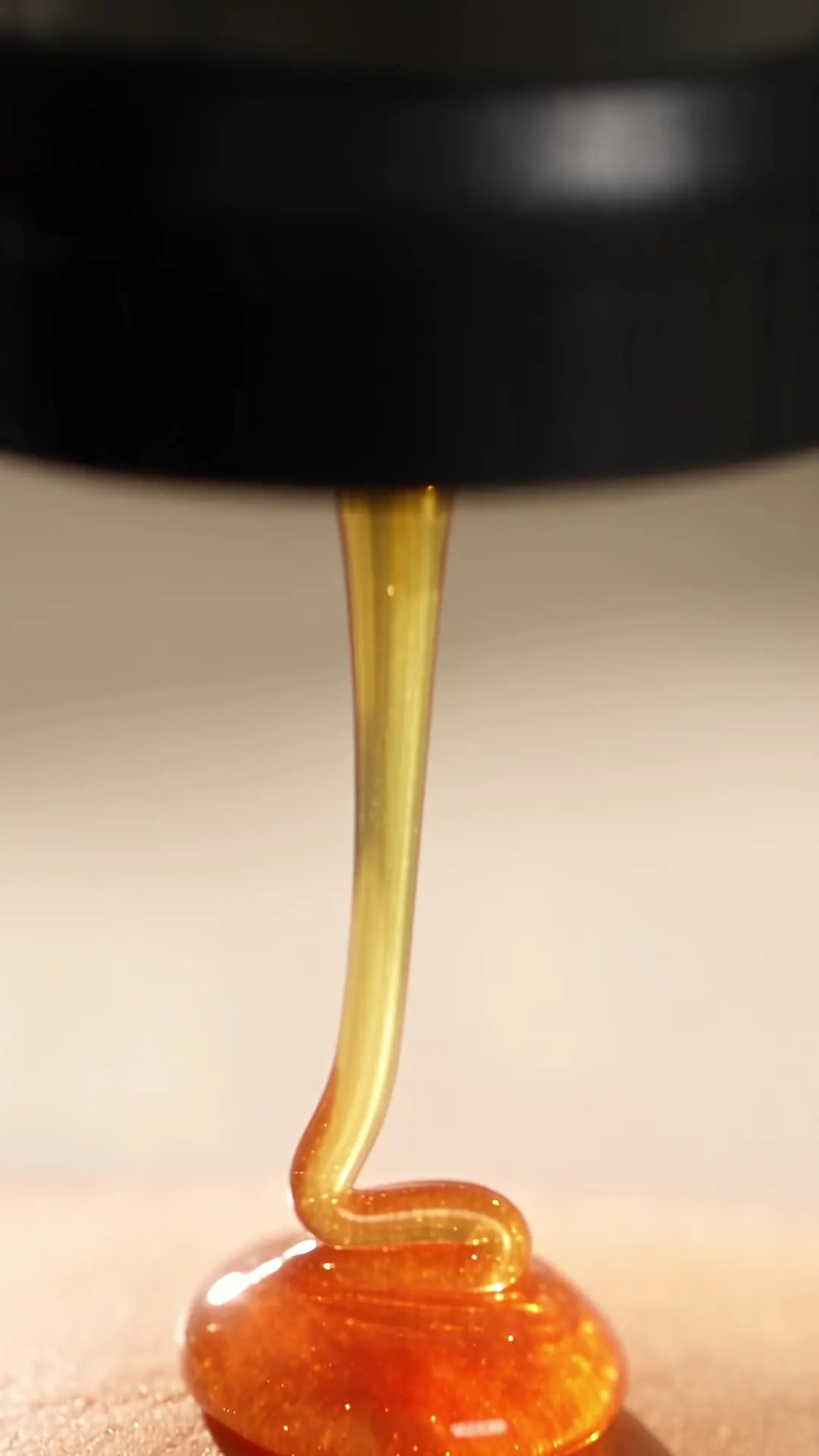 Close-up of a honey stream falling from the valve